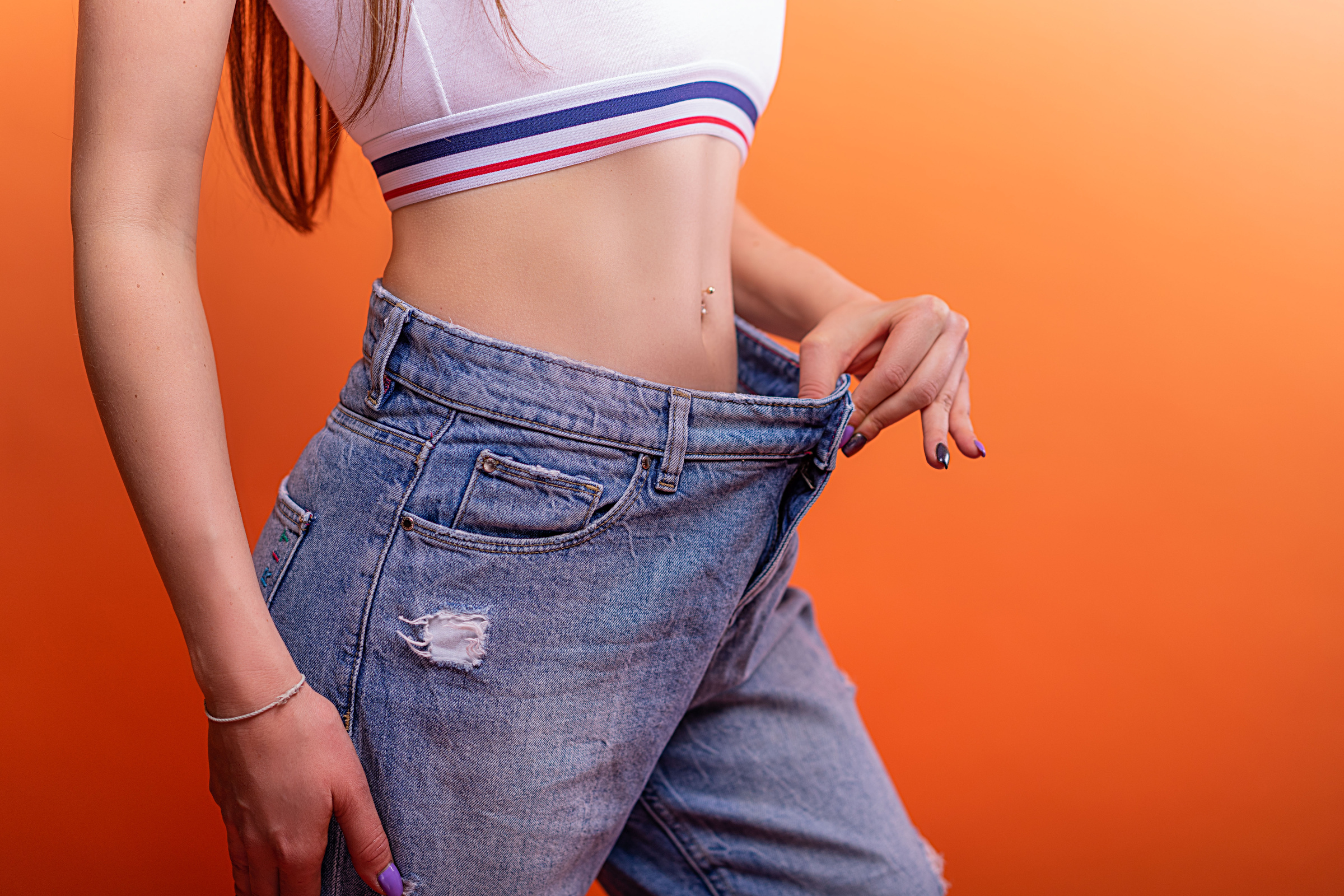 Woman Showing She Has Lost Weight